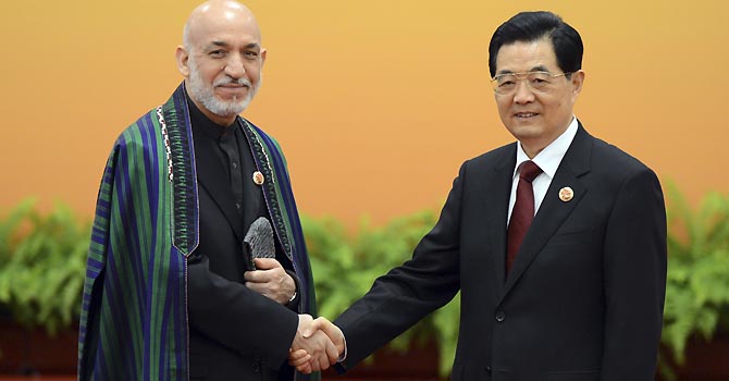 China Security Alliance Chinese President Hu Jintao, right, and Afghan President Hamid Karzai pose for photos before their meeting at the Shanghai Cooperation Organization (SCO) summit in the Great Hall of the People in Beijing, Thursday, June 7, 2012. (AP Photo/Mark Ralston, Pool)
