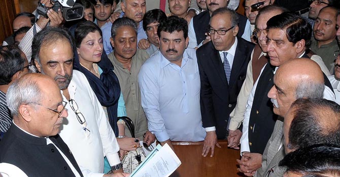 online-pm-nomination-online-670 Makhdoom Shahab-ud-Din alongwith other MNAs submitting his nomination papers for the election of Prime Minister to Secretary National Assembly, Karamat Hussain Niazi at Parliament House on Thursday. — Photo by ONLINE