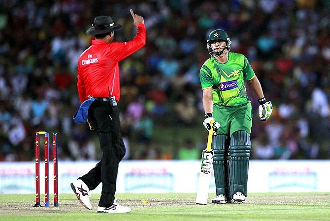 Pakistan's Khalid Latif (R) looks as umpire Ruchira Palliyaguru signals that he is run out. -Photo by Reuters
