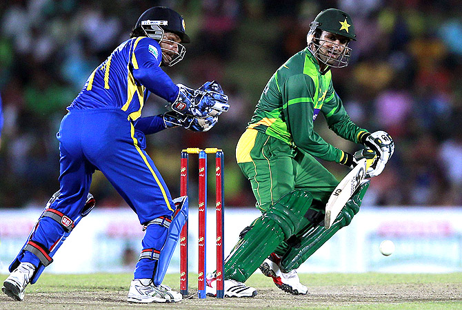 Pakistan's Shoaib Malik (R) plays a shot. -Photo by Reuters