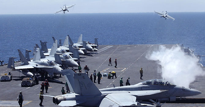 SKOREA-ASIA-SECURITY-SINGAPORE-US-CHINA-MILITARY-DIPLOMACY-FILES (FILES) This file photo taken on Juny 26, 2010 shows US fighters taking off from the flight deck of the Nimitz-class USS George Washington for joint military exercises between the US and South Korea in South Korea's East Sea. The United States will shift the majority of its naval fleet to the Pacific by 2020 as part of a new strategic focus on Asia, Pentagon chief Leon Panetta told a summit in Singapore on June 2, 2012. AFP PHOTO / FILES / Lee Jin-man