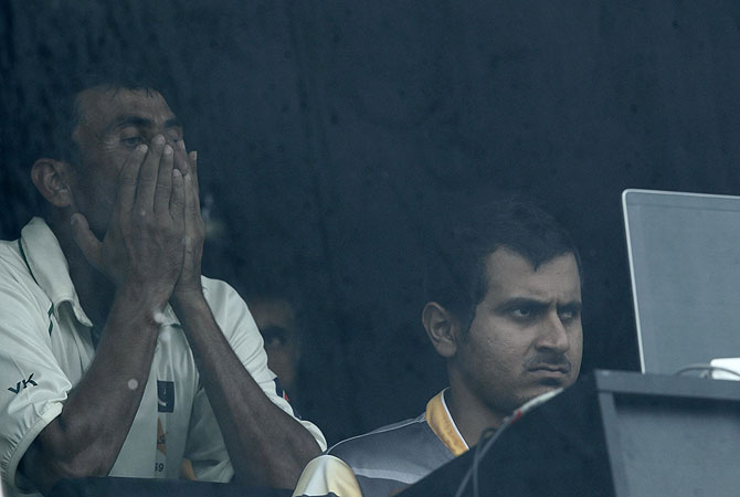 Younis (L) reacts as he watches his dismissal in the dressing room. -Photo by Reuters