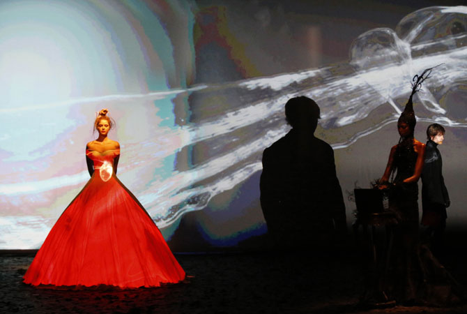 She wins the love of a royal prince, a beating heart appears on a blood red gown, giving way to a white dress with iridescent butterflies fluttering up and away, into the blue sky beyond. ? Photo by AFP