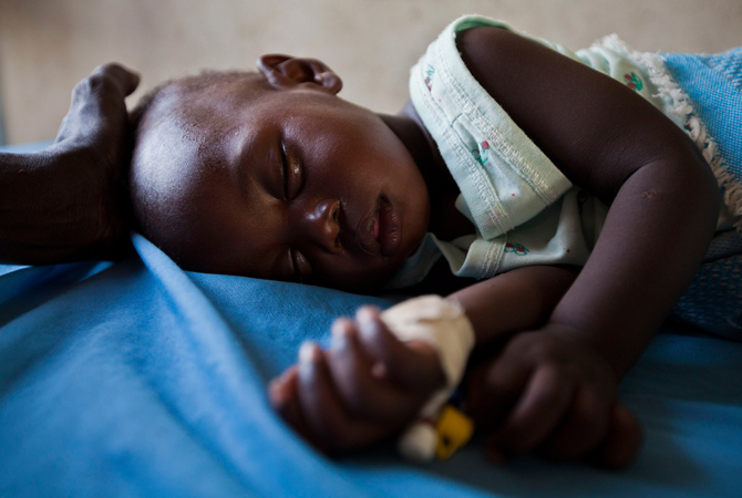 A young girl with malaria rests in the inpatient ward of the Malualkon Primary Health Care Center in Malualkon. Development experts have grown more sophisticated in recent decades about how they deliver aid. – Photo by Reuters