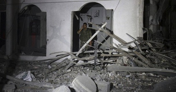 A-Palestinian-security-police-officer-inspects-the-damage-following-an-Israeli-air-strike-on-the-building670 A Palestinian security police officer inspects the damage following an Israeli air strike on the building.—AP Photo