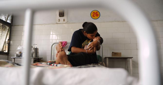 an-Indian-mother-kissing-her-new-born-daughter-in-a-maternity-ward-at-a-public-hospital-in-Nawanshahr670 An Indian mother kissing her new born daughter in a maternity ward at a public hospital in Nawanshahr. — AFP Photo