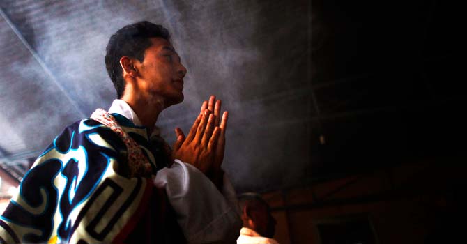 A Tibetan man prays at a monastery in Katmandu. ? Photo by AP