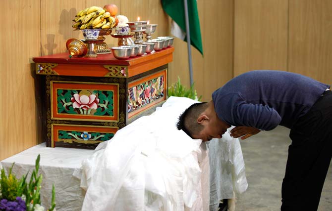 An exile Tibetan bows to pay his respect during birthday celebrations of spiritual leader the Dalai Lama, in Bangalore. ? Photo by AP