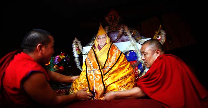 Tibetan monks place a portrait of spiritual leader the Dalai Lama at a monastery in Katmandu. ? Photo by AP