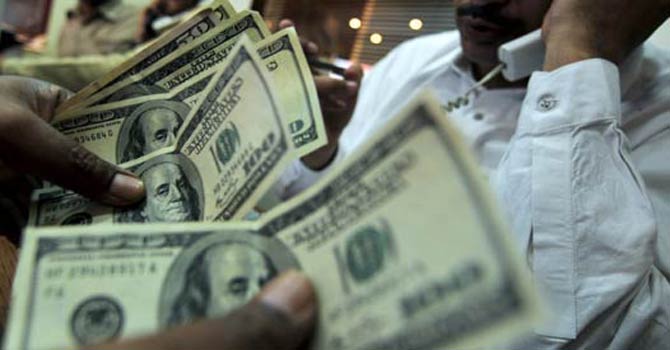 Forex_2_670 A trader counts US dollars. — File Photo