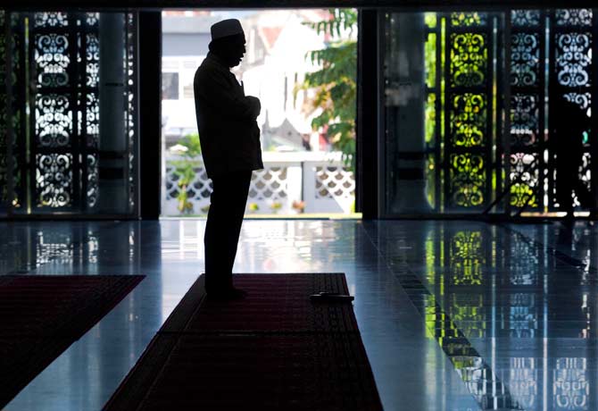 An Indonesian Muslim attends prayer at Baiturrahman mosque in Banda Aceh. ? Photo by AFP