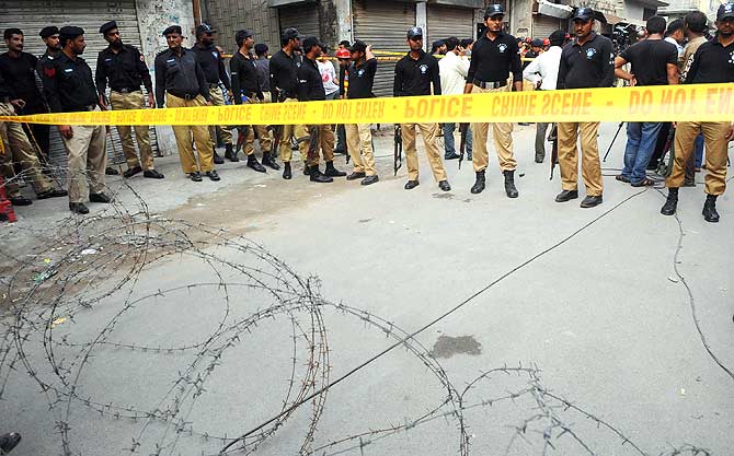 Policemen seal off an area, that was attacked by gunmen, outside a police hostel. ? Photo by AFP