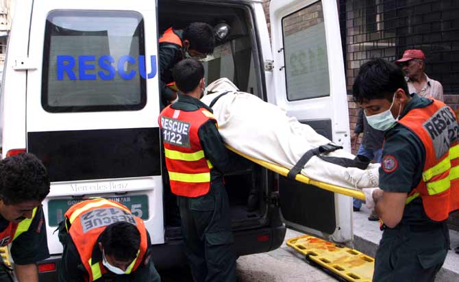 Rescue officials carry a dead body after an attack on police hostel.? Photo by AFP