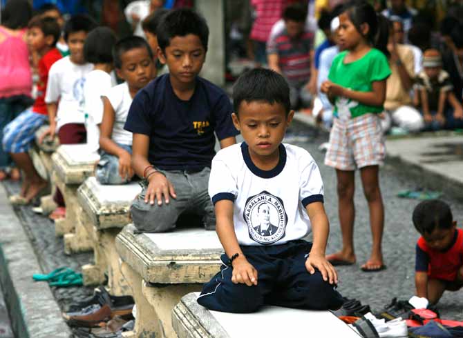 Muslim boys attend a mass prayer marking the start of Ramadan at the Golden Mosque in Quiapo, Metro Manila. ? Photo by Reuters