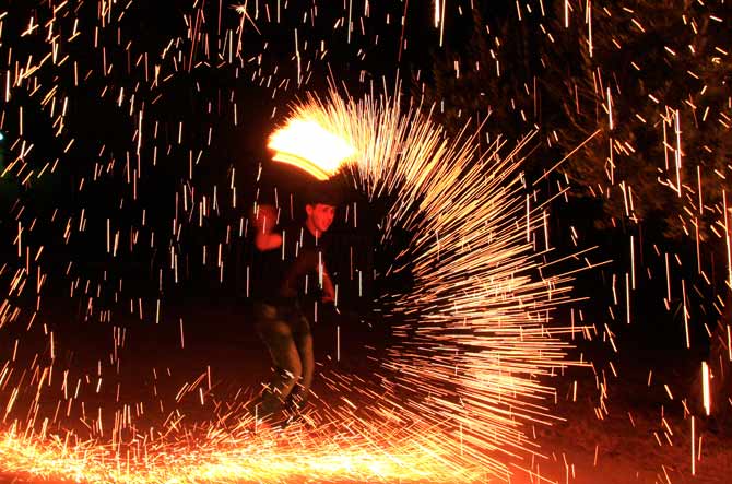A Palestinian boy plays with fireworks as he celebrates the start of Ramazan in the West Bank city of Nablus. ? Photo by AP