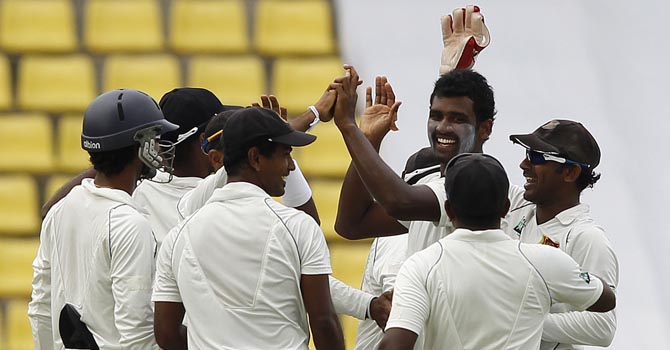 Sri Lanka's Perera celebrates with teammates after taking the wicket of Pakistan's Ali during their third test cricket match in Pallekele