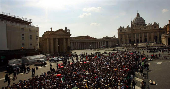 Pilgrims queue outside Saint Peter's Basilica as they wait to pay their respects to the late ...