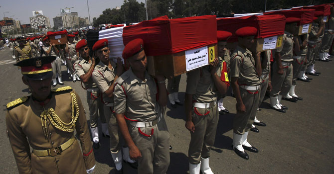 Coffins of soldiers killed during an attack at a checkpoint along the Sinai border with Israel by unknown gunmen, are carried by soldiers during a funeral at the tomb of the late former President Sadat and the Unknown Soldier monument, in Cairo Coffins of soldiers killed during an attack at a checkpoint along the Sinai border with Israel by unknown gunmen, are carried by soldiers during a funeral at the tomb of the late former President Anwar al-Sadat and the Unknown Soldier monument, in Cairo August 7, 2012. An Egyptian official said insurgents crossed into Egypt from the Gaza Strip before attacking the border station on Sunday, killing 16 police officers. REUTERS/Amr Abdallah Dalsh (EGYPT - Tags: POLITICS CIVIL UNREST MILITARY OBITUARY)