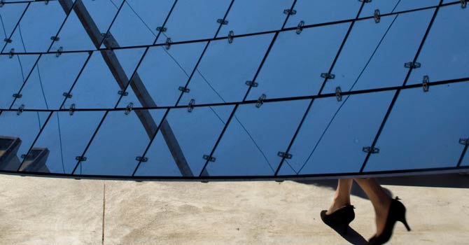 israel-solar-power-ap-2-670 A visitor walks by a solar dish at a solar farm, which according to the manufacturer, are revolutionary in the way they efficiently produce maximum energy using a minimal area, in Kibbutz Kvutzat Yavne, Israel. Israel has a peak solar capacity of 212 megawatts, the vast majority of which comes from rooftop installations, that accounts for less than 2 per cent of the nationwide capacity according to the government-owned Israel Electric Corporation. – File photo by AP