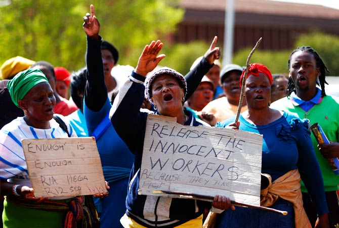Supporters of arrested, striking platinum mine workers demonstrate outside the court in Ga Rankuwa. – Photo by Reuters