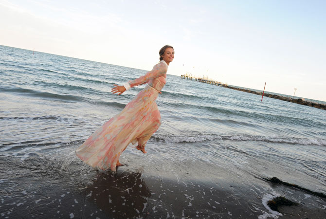The host of the festival, Polish-born actress and model Kasia Smutniak poses on the beach on the eve of the opening of the festival on August 28.