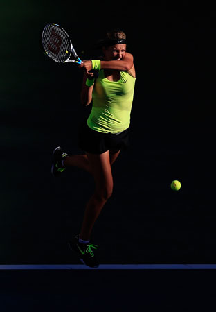 Victoria Azarenka of Belarus returns a shot during the women's singles final match against Serena Williams of the United States on Day Fourteen of the 2012 U.S. Open.