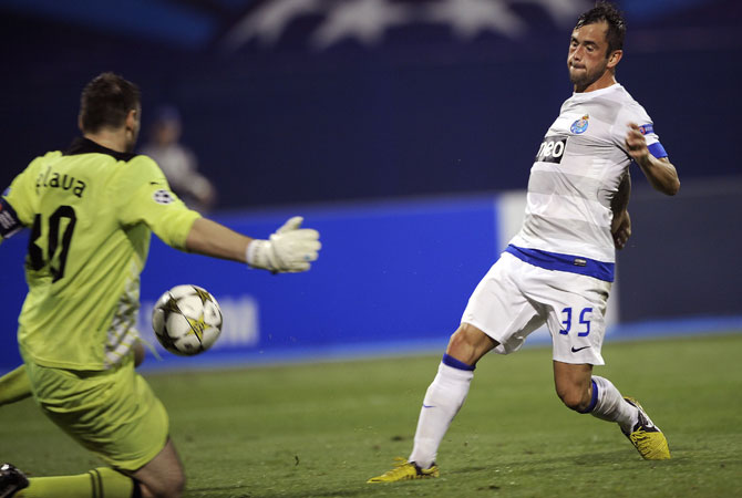 Porto's Steven Defour scores his team's second goal in front of Dinamo's goalkeeper Ivan Kelava (Left) during their Champions League group A football match. Porto won 2-0. ? Photo by AFP