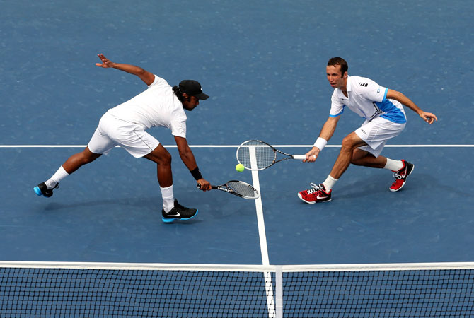 Leander Paes of India and Radek Stepanek of the Czech Republic play against Marcel Granollers and Marc Lopez of Spain during Day Eleven of the 2012 US Open.