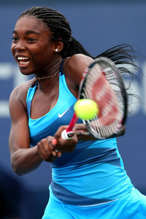 Francoise Abanda of Canada returns a shot during her girls' singles second round match against Katerina Siniakova of the Czech Republic on Day Eleven of the 2012 US Open.
