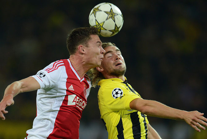 Ajax Amsterdam's forward Derk Boerrigter and Dortmund's defender Marcel Schmelzer (Right) vie for the ball during the UEFA Champions League group D. ? Photo by AFP