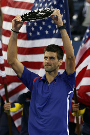 Novak Djokovic of Serbia lifts the runner's up award following his defeat in the men's singles final match against Andy Murray of Great Britain on Day Fifteen of the 2012 US Open.