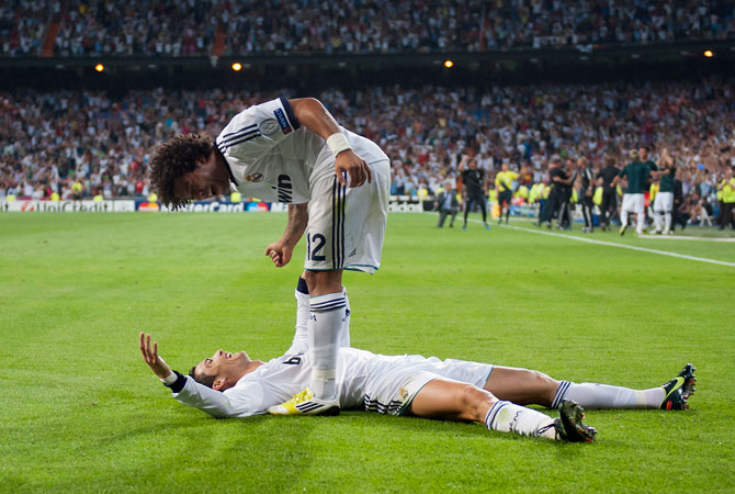 Real Madrid's Cristiano Ronaldo from Portugal, down, celebrates with Marcelo from Brazil after scoring a goal against Manchester City during a Champions League Group D match at the Santiago Bernabeu Stadium, in Madrid. ? Photo by AP