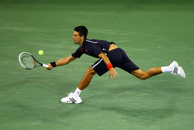 Novak Djokovic of Serbia returns a shot during his men's singles quarterfinal match against Juan Martin Del Potro of Argentina on Day Eleven of the 2012 US Open.