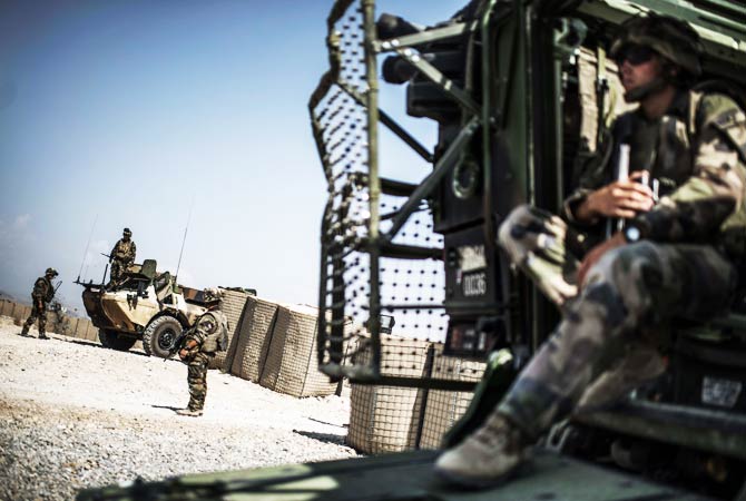 French soldiers wait in front of Naghlu base before heading back to their warehouse base in Kabul. ? Photo by AFP