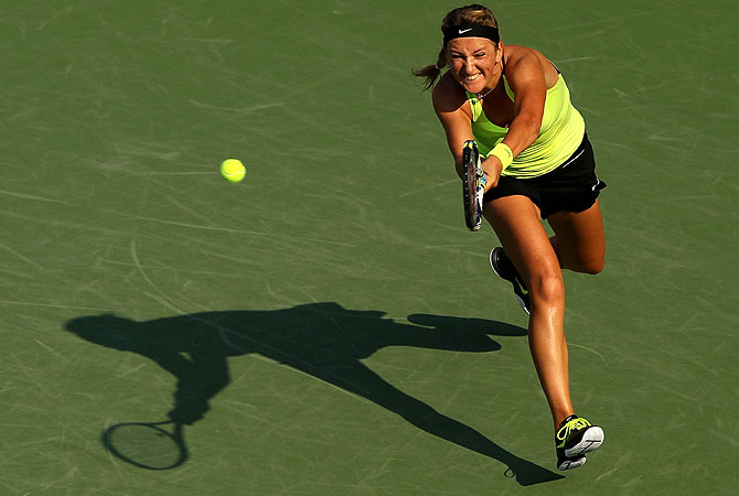 Victoria Azarenka of Belarus returns a shot during her women's singles semifinal match against Maria Sharapova of Russia. -Photo by AFP
