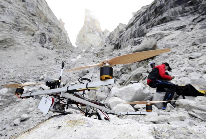 A team member gets ready to operate a helicopter over the Trango Summit.- Photo by AP