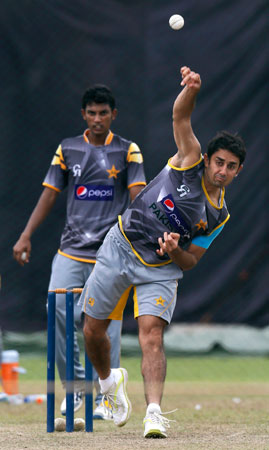 Pakistan's Saeed Ajmal, right, bowls as Raza Hasan watches during a practice session ahead of their ICC Twenty20 Cricket World Cup. ? Photo by AP