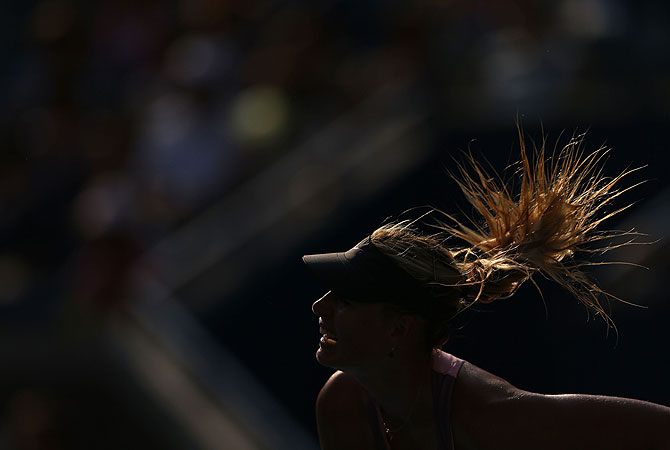 Maria Sharapova of Russia serves during her women's singles semifinal match against Victoria Azarenka of Belarus. -Photo by AFP