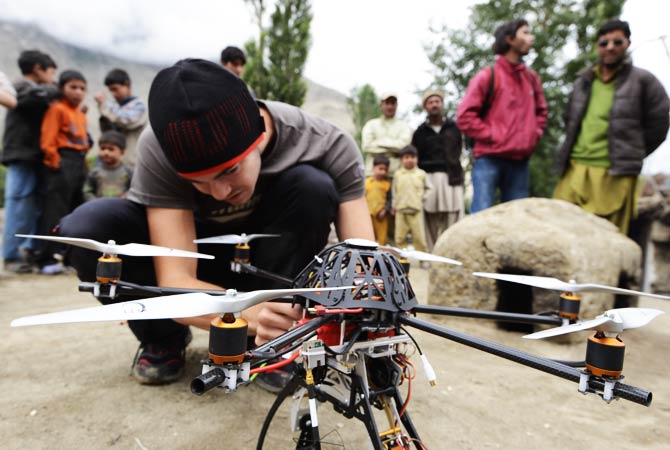 A team member prepares to fly a radio-controlled helicopter at the base of Trango Summit. ? Photo by AP