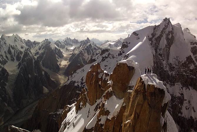 This photo is taken from a camera mounted to a remote-controlled helicopter showing Peter Ortner, Corey Rich and David Lama standing atop the Trango Summit. ? Photo by AP
