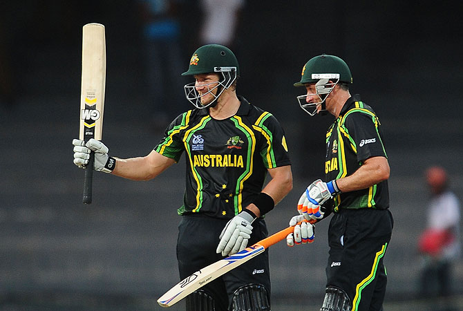 Watson (L) is watched by his teammate Michael Hussey as he raises his bat to the crowd after scoring a half-century. -Photo by AFP