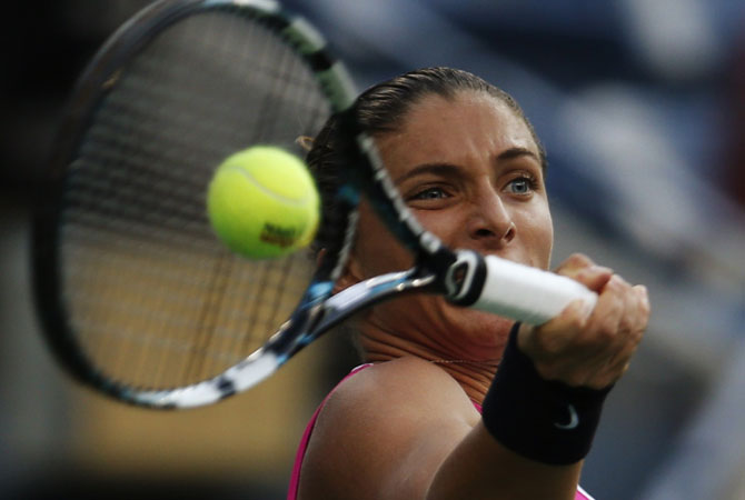 Sara Errani of Italy hits a return to Serena Williams of the US. -Photo by Reuters
