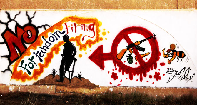 Graffiti on one of the city walls calls on people to stop random firing of weapons.