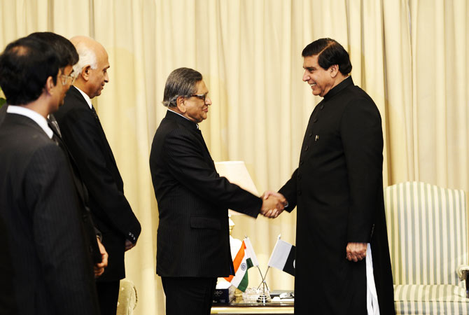 Indian Foreign Minister S.M. Krishna (2R) shakes hands with Pakistani Prime Minister Raja Pervez Ashraf (R) on his arrival for a meeting in Islamabad on September 7, 2012.