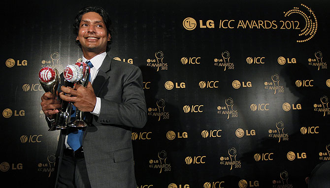Sri Lanka's Kumar Sangakkara, who won the International Cricket Council (ICC)'s Test Cricketer of the Year Award, People's Choice Award and Sir Garfield Sobers Trophy, poses with his awards. -Photo by Reuters