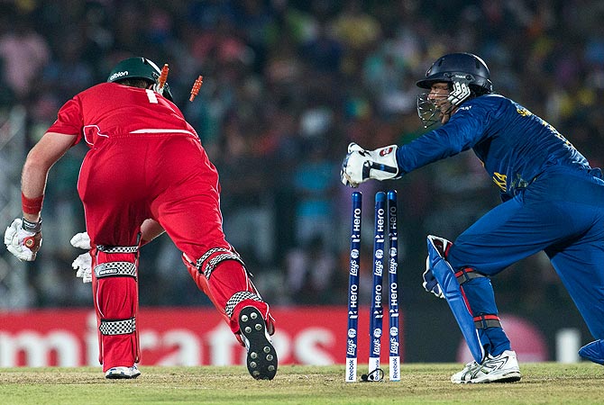 Sri Lanka's wicket keeper Kumar Sangakkara, right removes the bails to dismiss Zimbabwe's captain Brendan Taylor. -Photo by AP