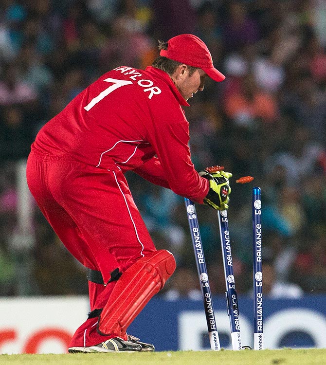 Zimbabwe's captain Brendan Taylor removes bails to dismiss Sri Lanka's Kumar Sangakkara. -Photo by AP