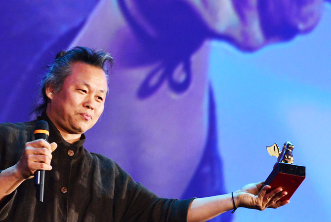 Korean film director Kim Ki-Duk holds the Golden Lion for best movie during the award ceremony of the 69th Venice Film Festival on September 8, 2012 at Venice Lido. South Korean director Kim Ki-duk's morality tale ?Pieta? won the Golden Lion for best movie at the Venice film festival.