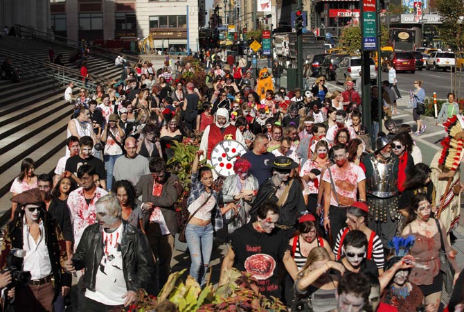 People dressed up as zombies walk on a street in New York. Hundreds of people took part in the event known as "ZOMBIECON" during Halloween celebrations and to pay homage to the character typically depicted as the mindless walking dead with a penchant for human flesh and brains, made popular in movies, books and comics.?Reuters Photo
