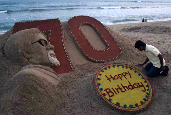 Indian sand artist Sudarshan Pattnaik applies the finishing touches to a sand sculpture of Bollywood's biggest star Amitabh Bachchan a day ahead of his 70th birthday, at the beach in Puri, India, Wednesday. ? Photo by AP